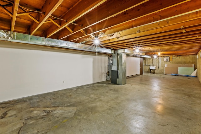 unfinished basement with heating unit and a sink