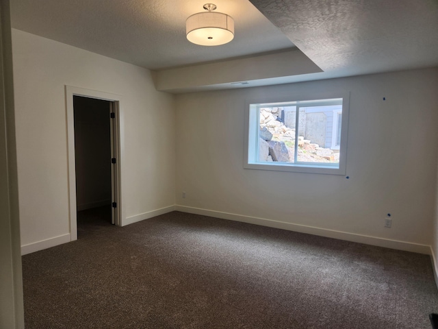 8712 E Ridgeline Ln, Spokane, WA 99217 - unfurnished bedroom featuring dark colored carpet and a textured ceiling