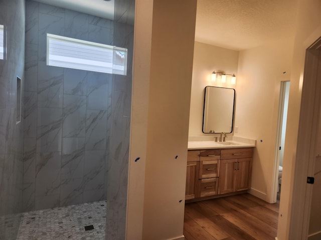 8712 E Ridgeline Ln, Spokane, WA 99217 - full bath featuring wood finished floors, walk in shower, and vanity