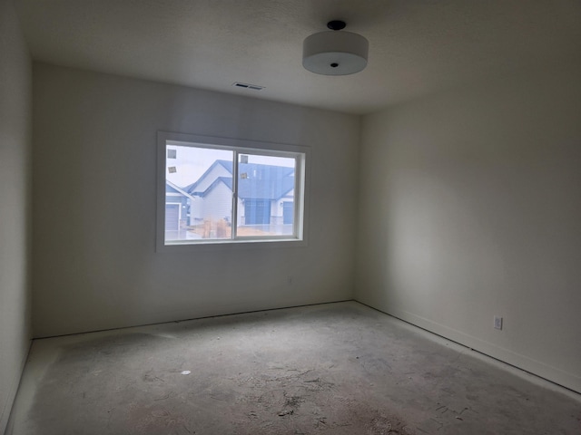 unfurnished room featuring visible vents