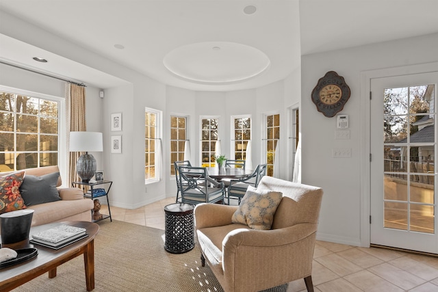 living room featuring baseboards and light tile patterned flooring