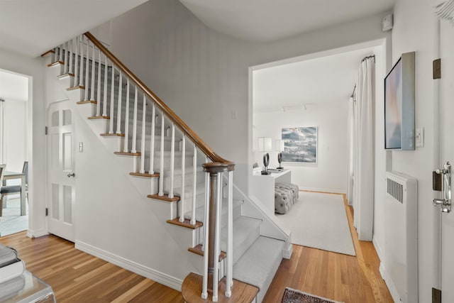 entryway featuring radiator, baseboards, and wood finished floors