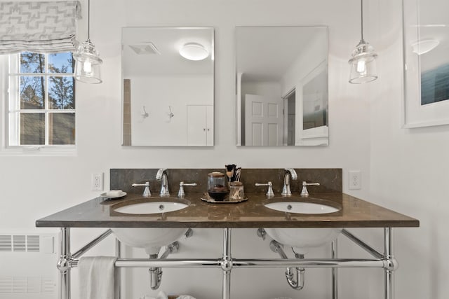 full bath featuring radiator heating unit, visible vents, and a sink