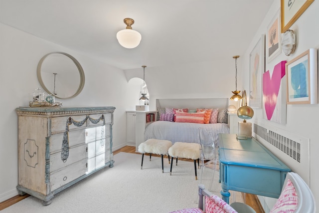 bedroom featuring wood finished floors and baseboards