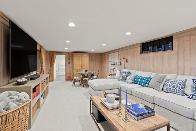 living room with recessed lighting, light carpet, and wood walls