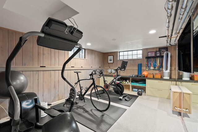 workout area featuring wooden walls and recessed lighting