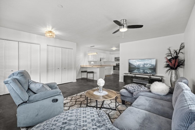 living room featuring finished concrete flooring and a ceiling fan