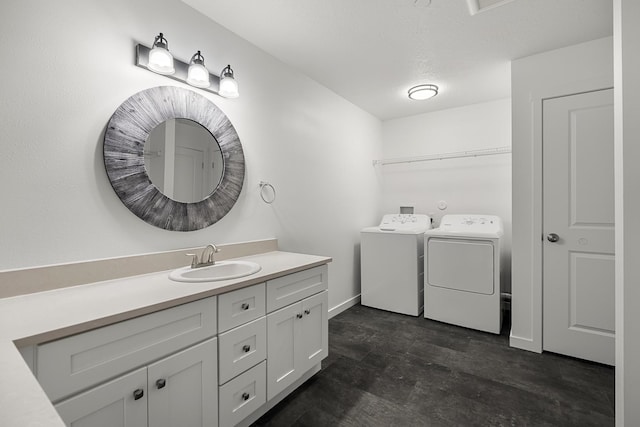 bathroom featuring independent washer and dryer, a textured ceiling, a closet, baseboards, and vanity