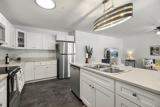 kitchen with a sink, light countertops, white cabinetry, and stainless steel appliances