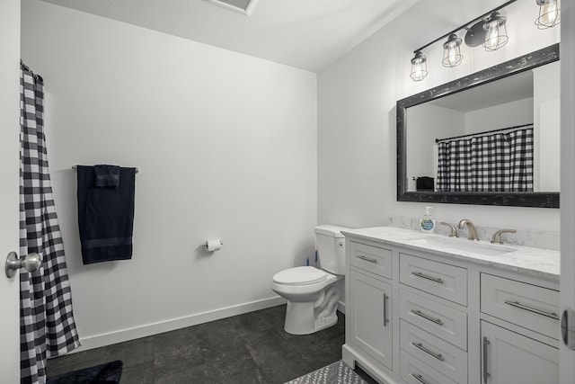 bathroom with baseboards, toilet, and vanity