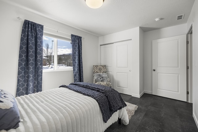 bedroom with visible vents, baseboards, and a closet