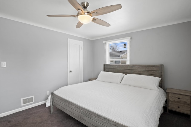 carpeted bedroom with visible vents, a ceiling fan, and baseboards