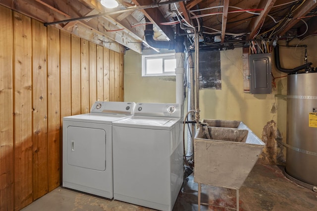 laundry room featuring secured water heater, laundry area, electric panel, a sink, and independent washer and dryer