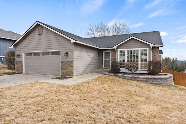 ranch-style home with fence, driveway, an attached garage, a front lawn, and stone siding