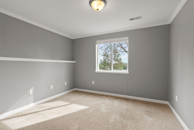 carpeted spare room featuring visible vents, crown molding, and baseboards