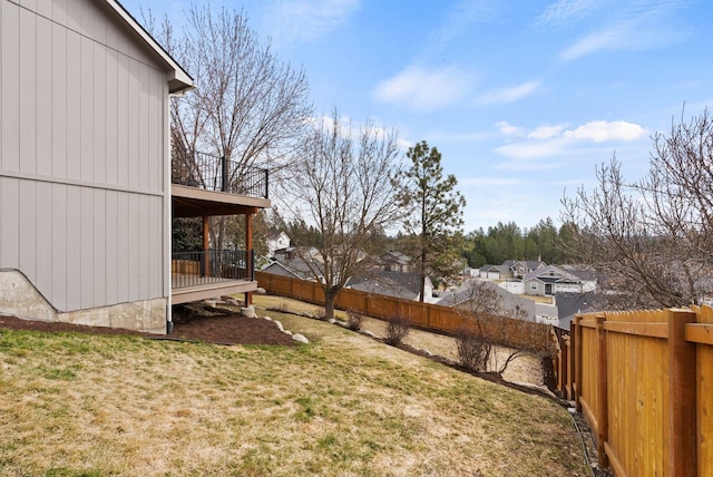 view of yard featuring a wooden deck and a fenced backyard