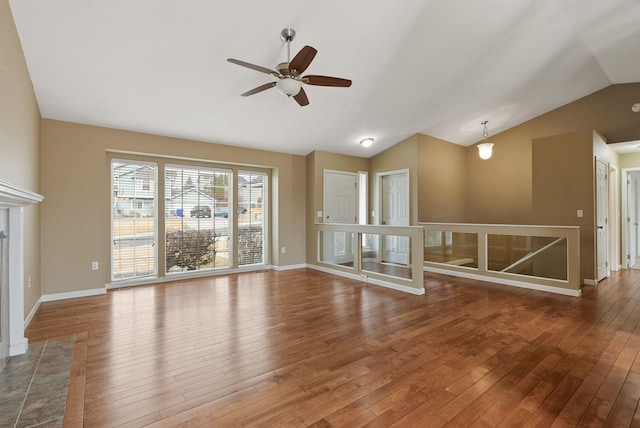 unfurnished living room with hardwood / wood-style floors, lofted ceiling, baseboards, and ceiling fan