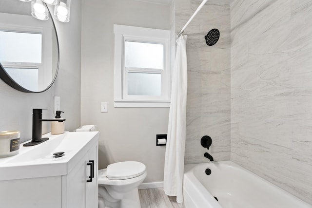 full bath with vanity, wood finished floors, baseboards, shower / bath combination with curtain, and toilet