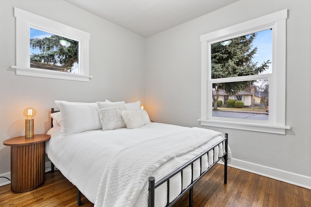 bedroom featuring baseboards and wood finished floors