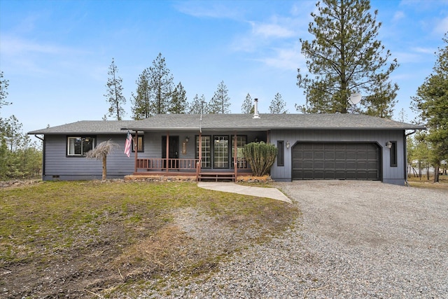 ranch-style home with roof with shingles, covered porch, a garage, crawl space, and driveway