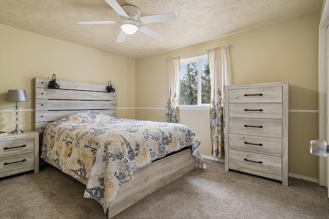 carpeted bedroom featuring baseboards, a textured ceiling, and ceiling fan