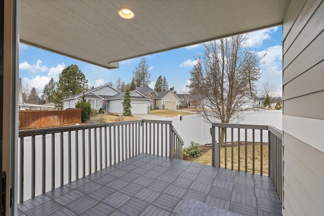 wooden deck featuring a residential view and a fenced backyard