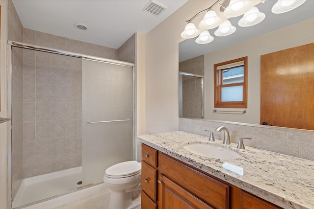 bathroom with visible vents, toilet, a stall shower, tile patterned flooring, and vanity