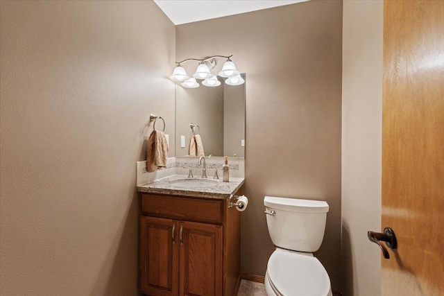 bathroom with toilet and vanity