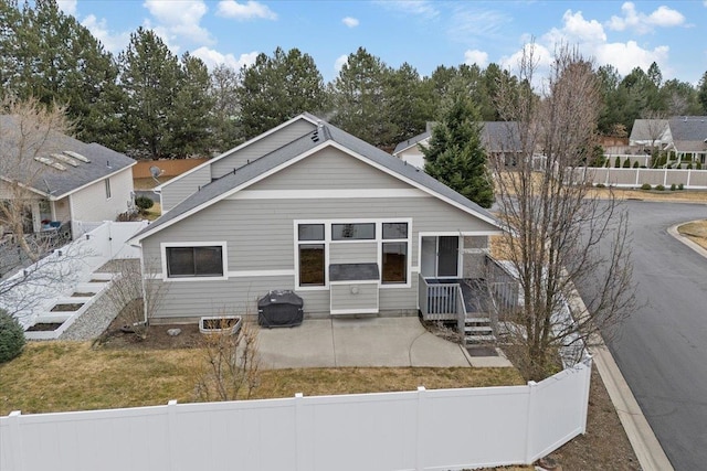 view of front of home with a fenced backyard and a patio area