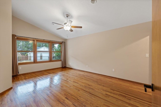 empty room with light wood-type flooring, ceiling fan, and vaulted ceiling