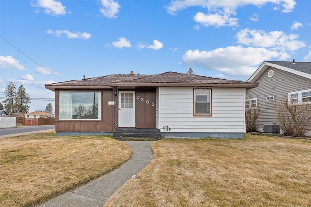 view of front of property with central AC unit, a front yard, and entry steps