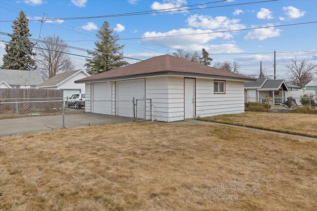 detached garage featuring a gate and fence