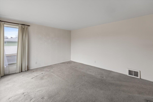 spare room featuring visible vents and carpet floors