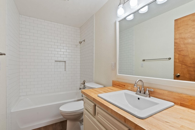 full bath featuring vanity, toilet, and shower / washtub combination