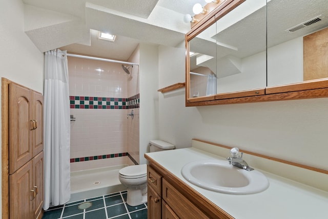 bathroom featuring visible vents, toilet, a textured ceiling, a shower stall, and vanity