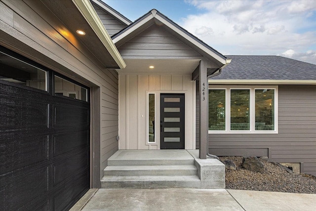 property entrance featuring board and batten siding and a shingled roof