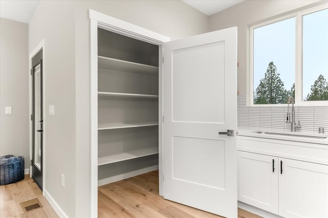 closet with a sink and visible vents