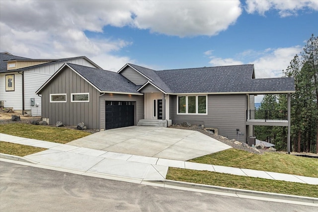 view of front facade with driveway, board and batten siding, an attached garage, and a shingled roof