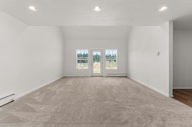 carpeted spare room featuring recessed lighting, a baseboard heating unit, and lofted ceiling