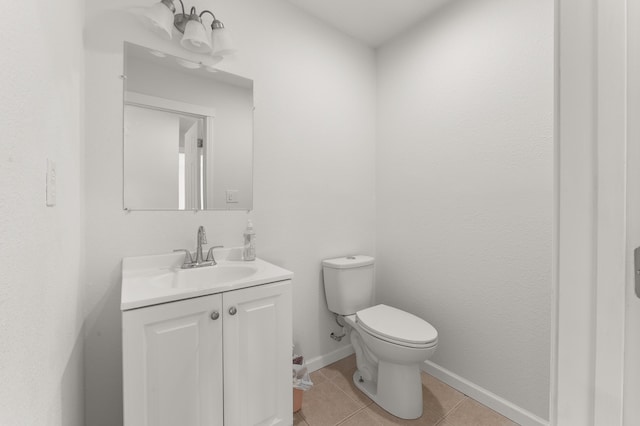 bathroom featuring tile patterned floors, baseboards, toilet, and vanity