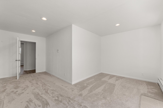 empty room with recessed lighting, carpet, baseboards, and a baseboard radiator