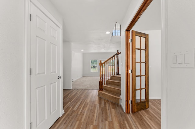 interior space featuring stairs, wood finished floors, and baseboards