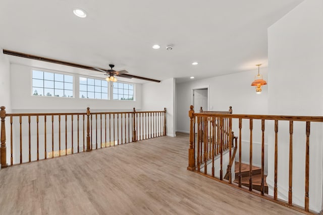 hall featuring an upstairs landing, recessed lighting, and wood finished floors