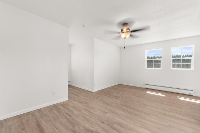 unfurnished room with a baseboard heating unit, baseboards, light wood-style flooring, and a ceiling fan