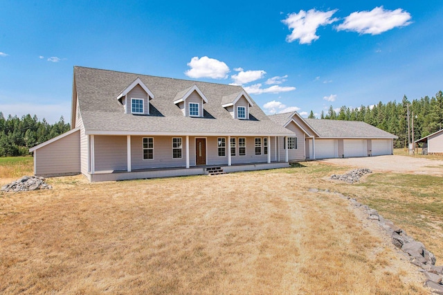 cape cod-style house with a front lawn, a porch, roof with shingles, a garage, and driveway