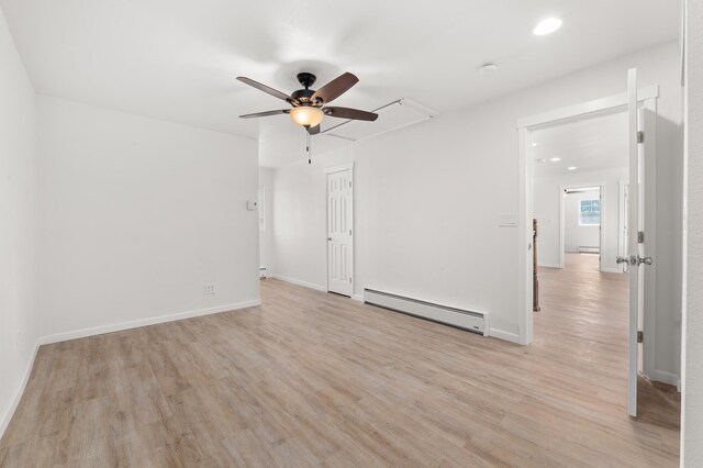 unfurnished room with a baseboard radiator, baseboards, ceiling fan, and light wood finished floors