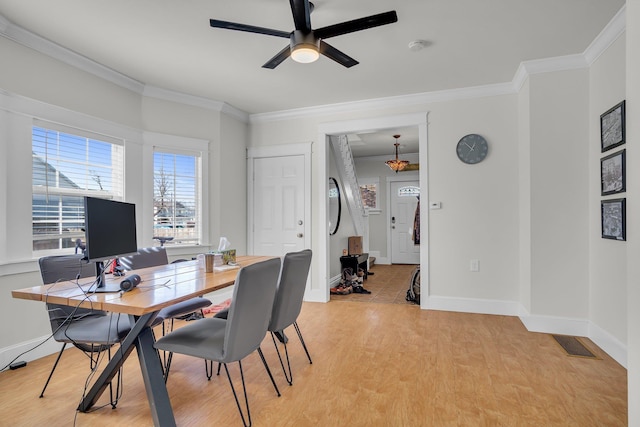 office space with crown molding, light wood-type flooring, and baseboards