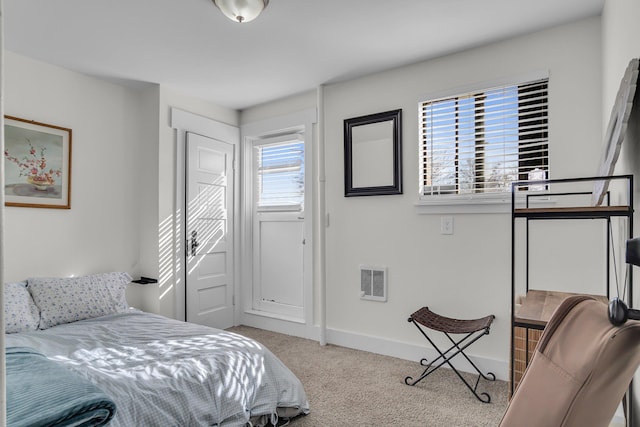 carpeted bedroom featuring visible vents and baseboards