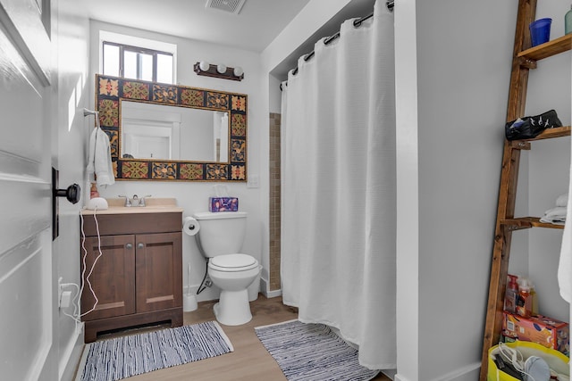 full bathroom with curtained shower, toilet, wood finished floors, and vanity