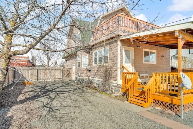 rear view of property featuring fence